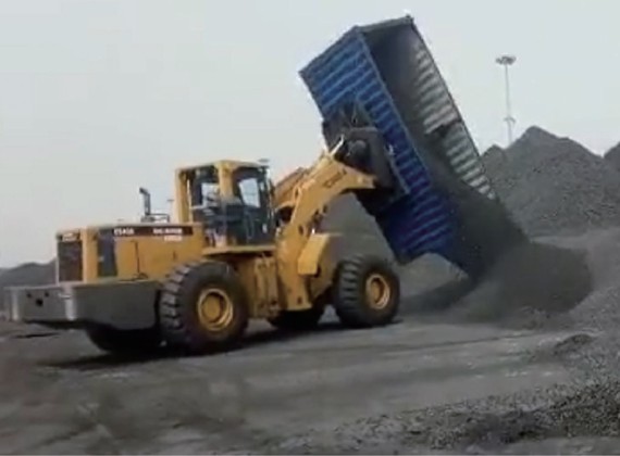 Container loader dumping coal